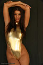Babe posing in shiny gold swimsuit.